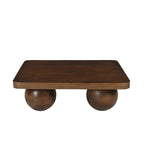 Table basse design en bois de manguier massif avec plateau carré et quatre pieds en forme de boules.