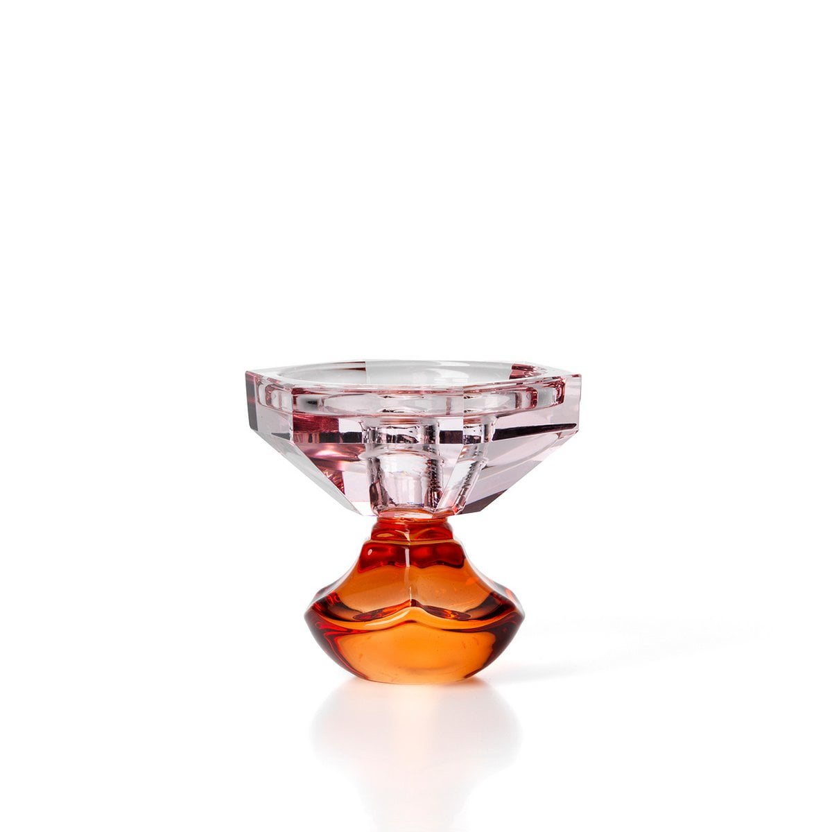 Petit bougeoir décoratif en verre rappelant un coucher de soleil, avec une base incurvée orange et un sommet facetté rose.
