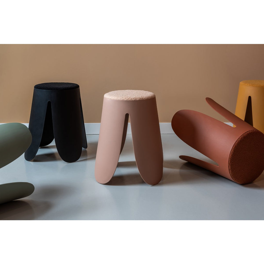 Mise en scène de plusieurs tabourets colorés dans un salon moderne.