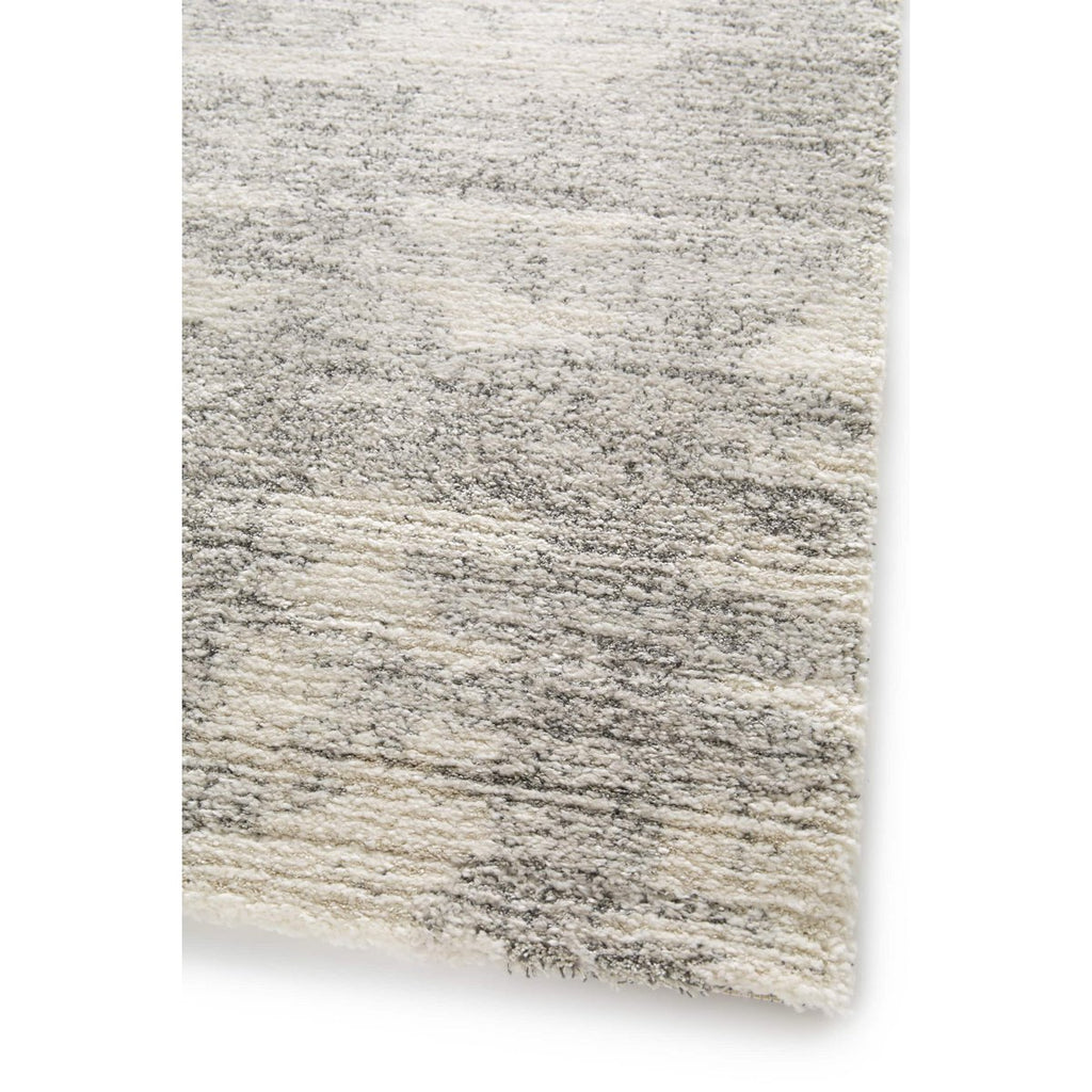 Gros plan sur la qualité du tissage belge aspect laine du tapis Brixy.