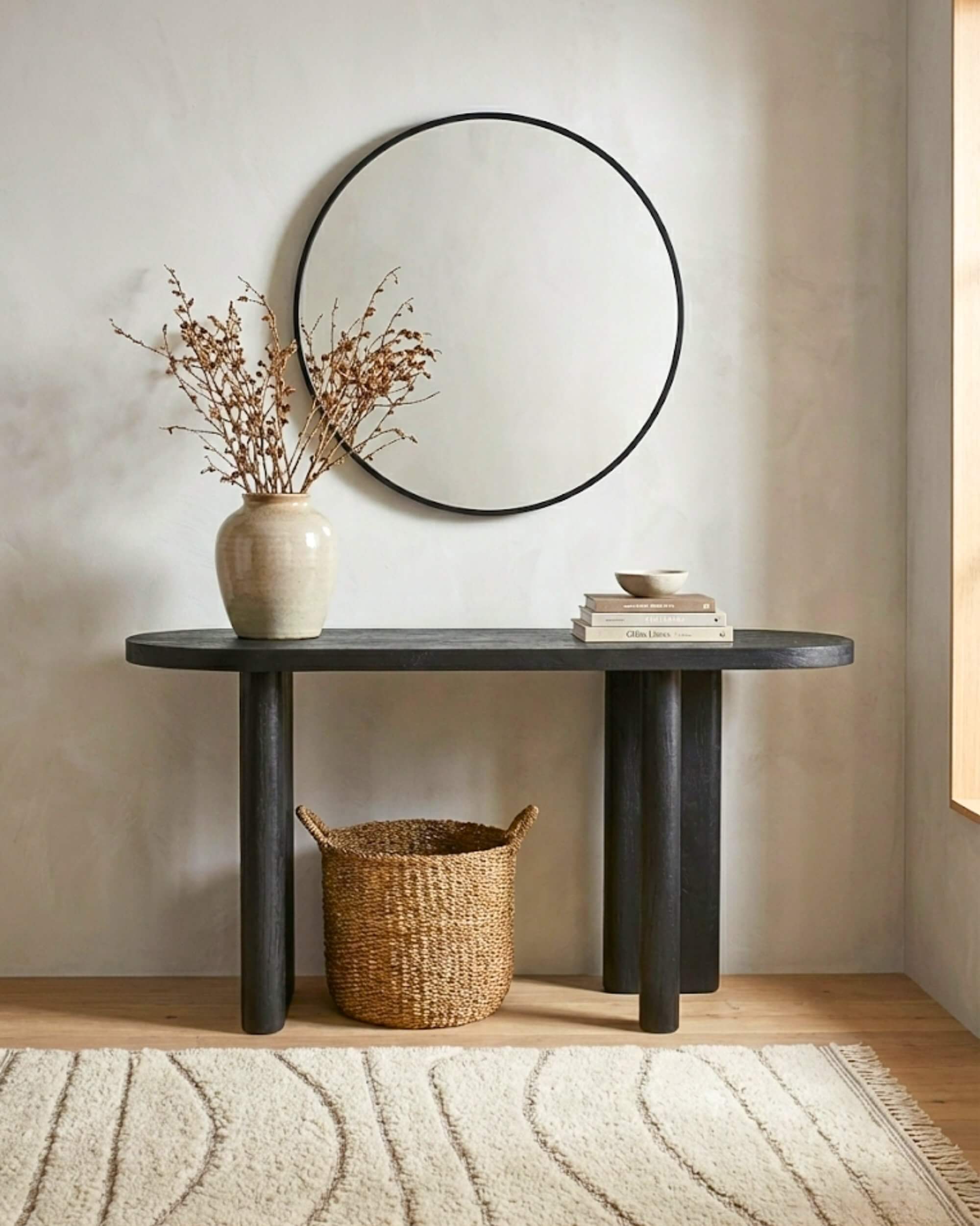 Table console noire 150cm en bois massif décorée avec panier et livres, ambiance wabi-sabi moderne.