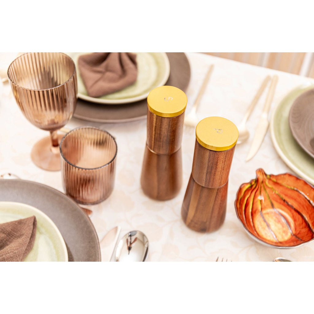 Set salière poivrière en bois mis en scène sur une table de fête élégante.