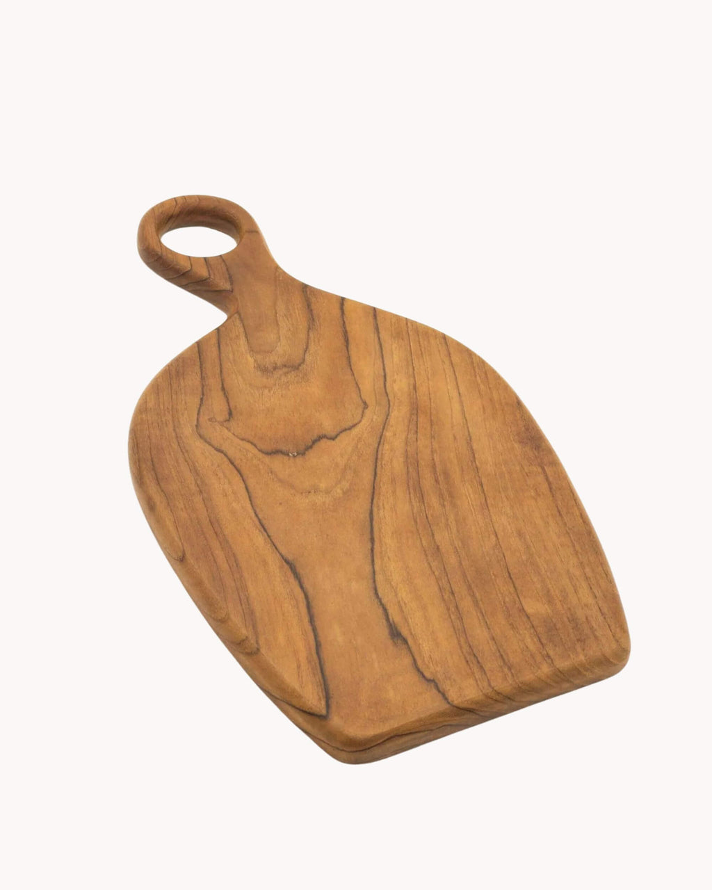 Planche de service DUMA en teck massif, forme organique et finition huilée.
